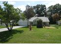 Well-maintained front yard featuring a fountain and manicured lawn at 8765 Sw 190Th Cir, Dunnellon, FL 34432