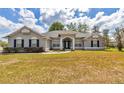 Attractive single-Gathering home with a well-maintained lawn and inviting entrance framed by white columns at 9859 Sw 45Th Ave, Ocala, FL 34476