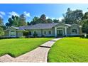 Inviting single-story home with well-manicured lawn and brick walkway leading to the front door at 7939 Se 12Th Cir, Ocala, FL 34480