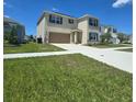 Two-story home featuring a spacious two car garage and a well manicured lawn at 1114 Brimstone Cir, Winter Haven, FL 33884