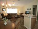 Bright and spacious living room with large windows, comfortable seating, and stylish decor at 11628 Sw 140Th Loop, Dunnellon, FL 34432
