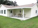 Enjoy outdoor living on this covered patio with comfortable seating and serene backyard views at 11628 Sw 140Th Loop, Dunnellon, FL 34432