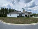 Corner lot featuring a single-story home, a well-kept lawn, and a convenient two-car garage, providing comfort and curb appeal at 12 Hickory Course Way, Ocala, FL 34472