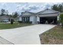 Inviting single-story home with a well-manicured lawn and a two-car garage, offering both visual appeal and practical parking at 12 Hickory Course Way, Ocala, FL 34472