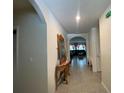 Inviting hallway featuring tile flooring, neutral walls, and decorative accents leading to a bright and airy living space at 12 Hickory Course Way, Ocala, FL 34472