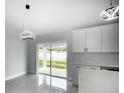 Modern kitchen featuring white cabinets, stainless steel appliances and a spacious kitchen island at 12180 Se 89Th Ter, Belleview, FL 34420