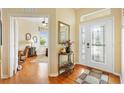 Elegant foyer featuring hardwood floors, decorative glass front door, and a view of the home office at 12255 Se 177Th Loop, Summerfield, FL 34491