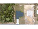 Overhead shot of a home with a dark roof, contrasted against the grass and a foundation for another structure at 16890 Sw 39Th Cir, Ocala, FL 34473