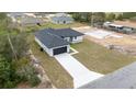 Picture of a single-Gathering home boasting a dark roof, a lengthy driveway, and a sizable, grassy front yard at 16890 Sw 39Th Cir, Ocala, FL 34473