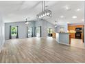 Spacious living room with vaulted ceilings, tile floors, and lots of natural light at 17902 Se 115Th Cir, Summerfield, FL 34491