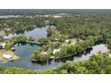 Stunning aerial view of a lake community surrounded by lush trees, showcasing waterfront homes at 19938 Burkitt Rd, Dunnellon, FL 34432