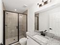 Modern bathroom featuring glass shower, tile surround, and granite vanity at 23964 Nw Falcon Ave, Dunnellon, FL 34431
