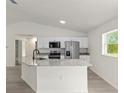 Open kitchen featuring stainless appliances, granite countertops, and island sink at 23964 Nw Falcon Ave, Dunnellon, FL 34431