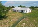 Lovely home with a metal roof on a well-manicured lot with a fenced pasture at 258 Nw 122Nd Ave, Oxford, FL 34484