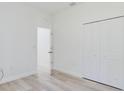 Bright bedroom with a closet and light wood-look floors that add a touch of warmth at 2627 Sw 154Th Place Rd, Ocala, FL 34473