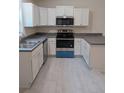 Modern kitchen featuring white cabinets, stainless steel appliances, and sleek countertops at 267 Oak Lane Trak, Ocala, FL 34472