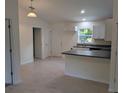 Open-concept kitchen with a breakfast bar, ample counter space, and modern lighting at 267 Oak Lane Trak, Ocala, FL 34472