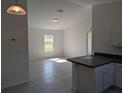 Sunlit living room showcases an open layout with an adjacent kitchen at 2803 Sw 147Th Ct, Ocala, FL 34481