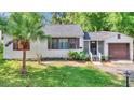 Inviting exterior showcasing a well-maintained lawn, mature landscaping, and a charming facade at 426 Sw 13Th St, Ocala, FL 34471
