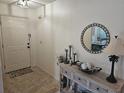 Inviting entryway with decorative console table, accent mirror, and tile flooring for a warm welcome at 5024 Se 107Th Pl, Belleview, FL 34420