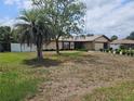 Inviting single-story home with a spacious front yard, mature trees, and attached garage at 516 Marion Oaks Dr, Ocala, FL 34473