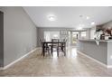 Spacious dining room area with decorative lighting and views into the kitchen at 60 Hemlock Trl, Ocala, FL 34472
