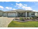 Well-maintained single-story home with landscaped front yard and a spacious two-car garage at 8457 Sw 97Th Cir, Ocala, FL 34481