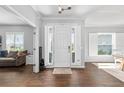 Inviting foyer with wood-look tile floors, natural light, and views to the dining and living areas at 9940 Sw 45Th Ave, Ocala, FL 34476