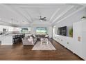 Open-concept living room with tray ceilings, wood-look tile floors, and access to the kitchen at 9940 Sw 45Th Ave, Ocala, FL 34476