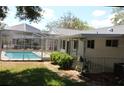 Private backyard featuring a screened-in pool area, and lush landscaping, creating a serene outdoor retreat at 10843 Sw 91St Ter, Ocala, FL 34481