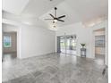 Open living space with tile flooring, high ceilings and sliding glass doors leading to the screened-in lanai at 17755 Se 117Th Cir, Summerfield, FL 34491