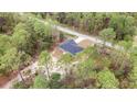 Aerial view showcasing this home's location surrounded by lush greenery and a tranquil neighborhood at 24144 Nw Water Oak Ave, Dunnellon, FL 34431
