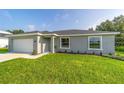 Charming single-story home with a well-manicured lawn, attached garage, and neatly landscaped front yard at 4365 Sw 151St St, Ocala, FL 34473