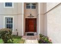 Inviting front door with decorative details, sidelights, and a tiled walkway at 4620 Sw 42Nd St, Ocala, FL 34474