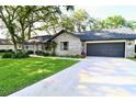 Charming single story brick home with a well-manicured lawn and a two car garage at 5351 Sw 80Th Pl, Ocala, FL 34476