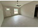 Living room featuring high ceilings, a ceiling fan, and gray tile floors at 5359 Nw 55Th Pl, Ocala, FL 34482