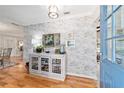 Elegant entryway featuring wood floors, decorative wall texture, and stylish furnishings at 5521 Sw 31St St, Ocala, FL 34474