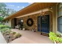 Inviting front porch with stone accents, a stylish light fixture, and a cozy seating area at 5521 Sw 31St St, Ocala, FL 34474