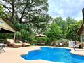 Beautiful pool surrounded by lush landscaping and comfortable seating, ideal for outdoor relaxation and enjoyment at 5521 Sw 31St St, Ocala, FL 34474