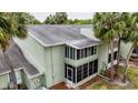 Corner-view of the two-story condo shows the screened in porch and well-maintained gray roof at 559 Fairway Circle # A, Ocala, FL 34472