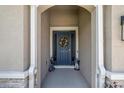 Welcoming entryway with a blue front door adorned with a decorative wreath at 5862 Sw 80Th Ln, Ocala, FL 34476