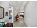 Inviting hallway with neutral walls and tile flooring that leads to the living areas and bedrooms at 5862 Sw 80Th Ln, Ocala, FL 34476