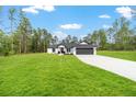 Beautiful single-story home set on a spacious lot with lush green lawn and mature trees at 7483 Sw 121St Ter, Dunnellon, FL 34432