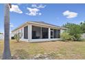 View of the screened-in lanai extending across the back exterior, offering a comfortable and bug-free outdoor space at 808 Overlook Grove Dr, Winter Haven, FL 33884