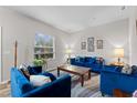 Cozy living room featuring modern decor, large window, and plush blue seating arrangement on stylish rug at 808 Overlook Grove Dr, Winter Haven, FL 33884