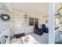 Inviting front porch featuring comfortable seating, brick accents, and a welcoming entrance with stylish door wreath at 8712 Sw 92Nd St # C, Ocala, FL 34481