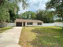 A well kept single Gathering home with a garage, manicured lawn and modern windows at 9 Pine Radial Ct, Ocala, FL 34472
