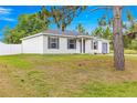 Charming single-story home with a well-maintained lawn, a grey roof and shutters, and a paved driveway at 97 Dogwood Cir, Ocala, FL 34472