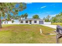 Charming single-story home with a well-maintained lawn, a grey roof and shutters, and a paved driveway at 97 Dogwood Cir, Ocala, FL 34472