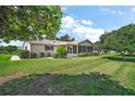 Spacious backyard with lush green grass and mature trees, offering plenty of room at 10347 Se 178Th Pl, Summerfield, FL 34491
